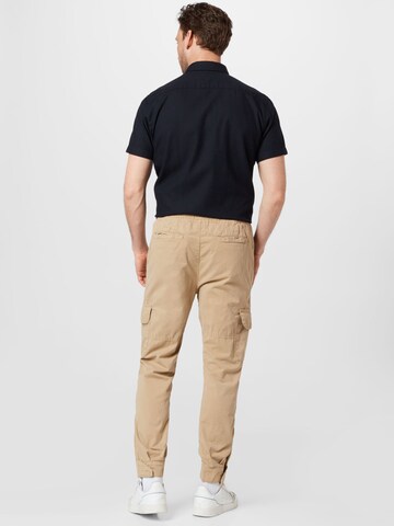 Effilé Pantalon cargo Urban Classics en beige