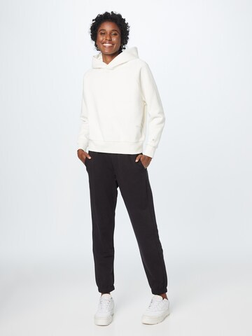 Champion Authentic Athletic Apparel - Tapered Pantalón 'Legacy' en negro