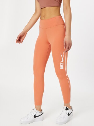 Skinny Pantalon de sport NIKE en orange : devant