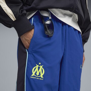 PUMA Loosefit Sportbroek 'Olympique De Marseille FtblEssentials Cellerator' in Blauw