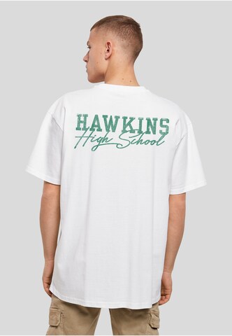 Merchcode Tričko 'Stranger Things Hawkins Tigers' – bílá