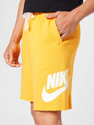 Nike Sportswear Широка кройка Панталон 'CLUB ALUMNI' в оранжево