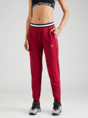 NIKE Tapered Sports trousers in Red: front