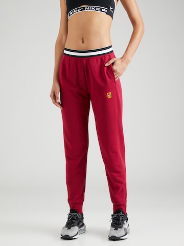 NIKE Tapered Workout Pants in Red: front