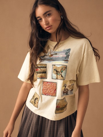 Next Tričko – žlutá: přední strana