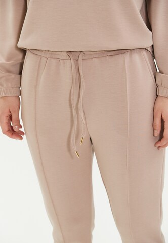 Athlecia Skinny Workout Pants 'Jacey' in Beige