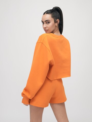 ABOUT YOU x VIAM Studio Sweatshirt 'BRITNEY' in Orange: back