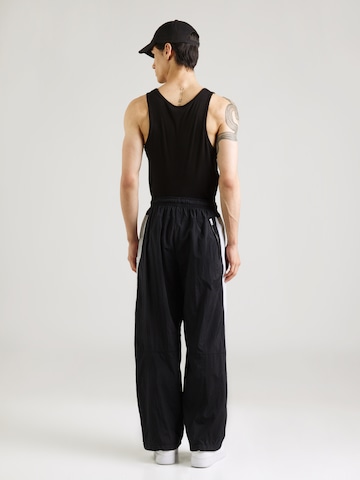 Nike Sportswear Ohlapna forma Hlače 'AIR' | črna barva