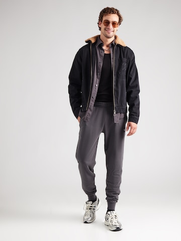 PUMA Zúžený Kalhoty 'ESS' – šedá