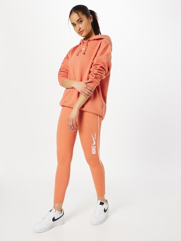 NIKE Skinny Urheiluhousut värissä oranssi