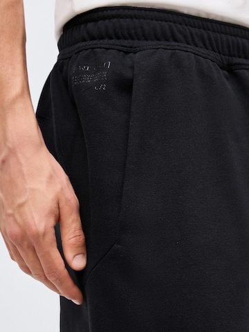 NIKE Loosefit Παντελόνι φόρμας 'NAC FLC' σε μαύρο