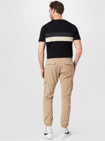 Effilé Pantalon cargo Urban Classics en beige