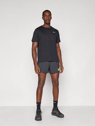 NIKE Ohlapna forma Športne hlače 'CITY MRTH STRIDE' | črna barva