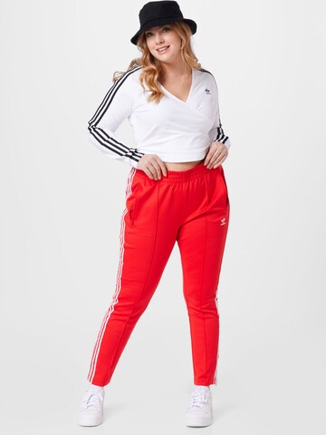 Slimfit Pantaloni de la ADIDAS ORIGINALS pe roșu