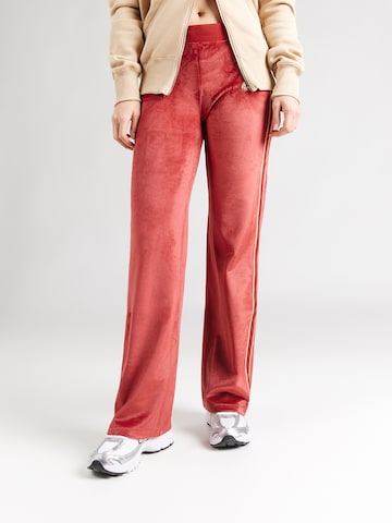 Nike Sportswear Lużny krój Spodnie w kolorze pomarańczowy: przód