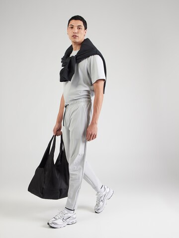 Effilé Pantalon de sport 'UNLIMITED' NIKE en gris