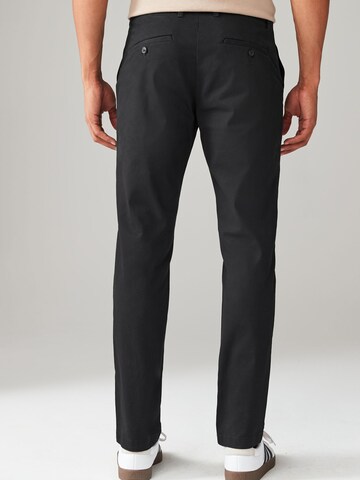 Slimfit Pantaloni chino di Next in nero