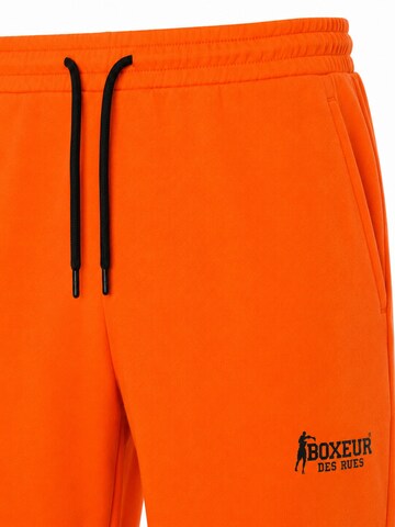 Boxeur des Rues - regular Pantalón deportivo 'Herren Baumwollshorts Boxeur des Rues, Orange, Schwarzes Logo' en naranja