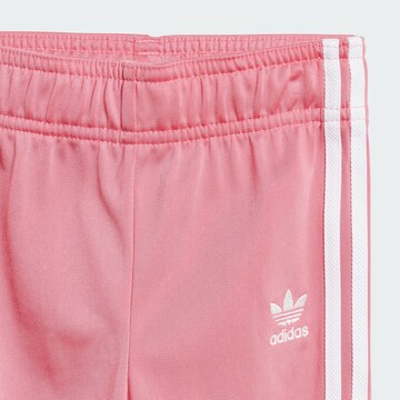ADIDAS ORIGINALS Träningsoverall 'Adicolor' i rosa