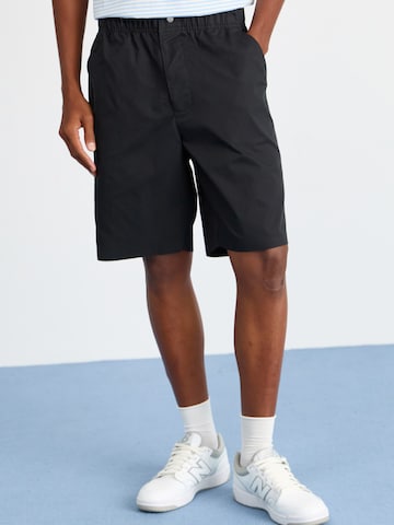 ELLESSE Loose fit Trousers 'Cagola' in Black: front
