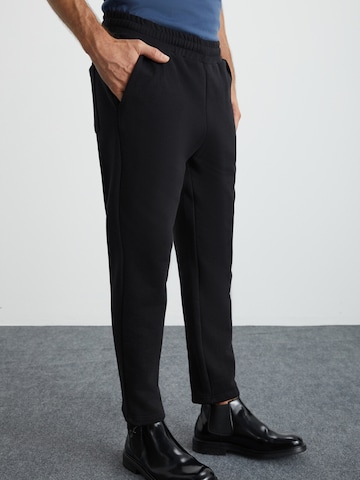 Grimelange Regular Trousers in Black: front