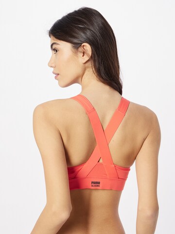 Bustino Reggiseno sportivo di PUMA in arancione