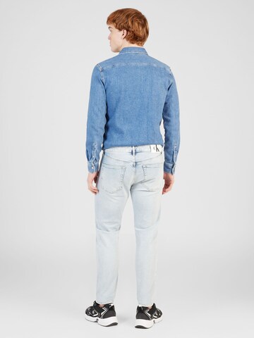 Coupe slim Jean 'SLIM TAPER' Calvin Klein Jeans en bleu