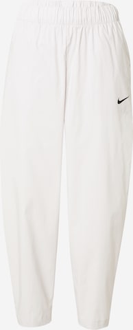 NIKE Sports trousers in Brown: front