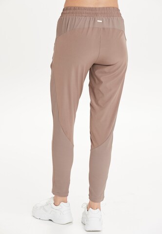 Athlecia Regular Workout Pants 'Timmie' in Beige