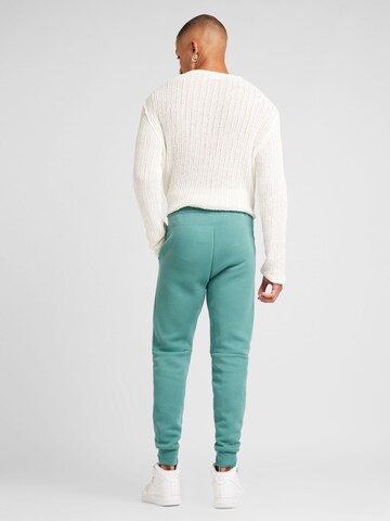Tapered Pantaloni 'Tech Fleece' de la Nike Sportswear pe verde