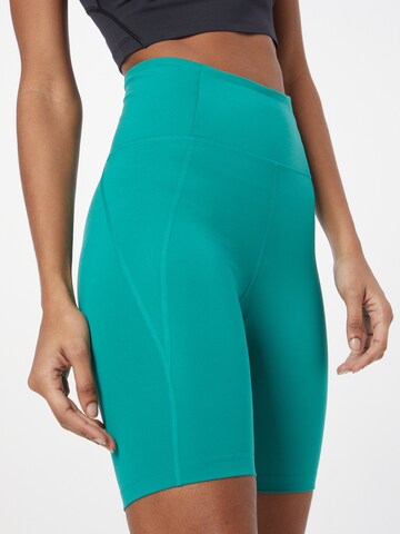 Skinny Pantaloni sportivi di Girlfriend Collective in verde