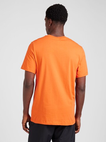 Nike Sportswear - Camiseta 'SWOOSH' en naranja