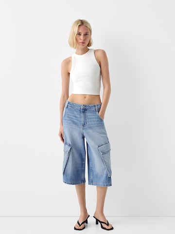 Bershka Zvonové kalhoty Džíny s kapsami – modrá