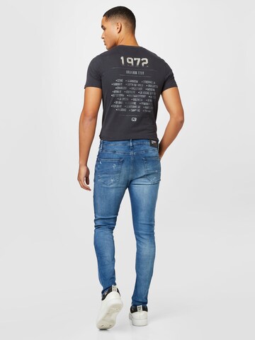 TOMMY HILFIGER Slimfit Farkut 'Austin' värissä sininen