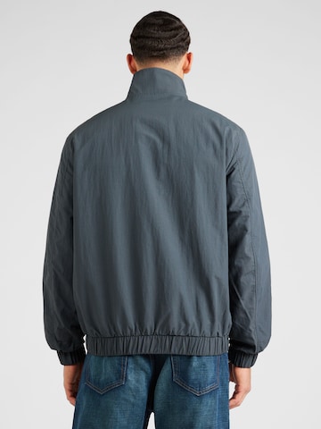 Tommy Jeans Övergångsjacka 'Essential' i grå