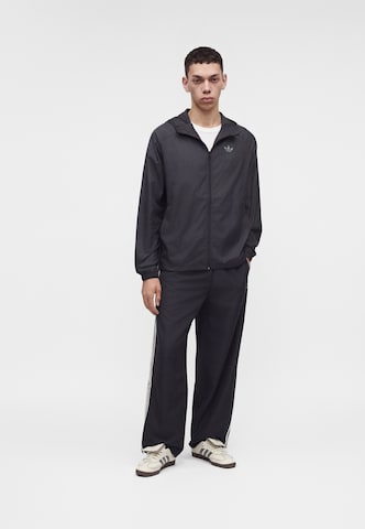 ADIDAS ORIGINALS Between-season jacket 'TECH ESS' in Black: front