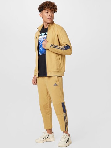 ADIDAS SPORTSWEAR Urheilullinen collegetakki 'Tiro' värissä beige