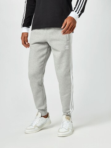 ADIDAS ORIGINALS Tapered Broek 'Adicolor Classics 3-Stripes' in Grijs: voorkant