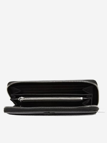 LACOSTE - Cartera 'Lacoste Compagnon cuir piqué unisexe Chantaco' en negro