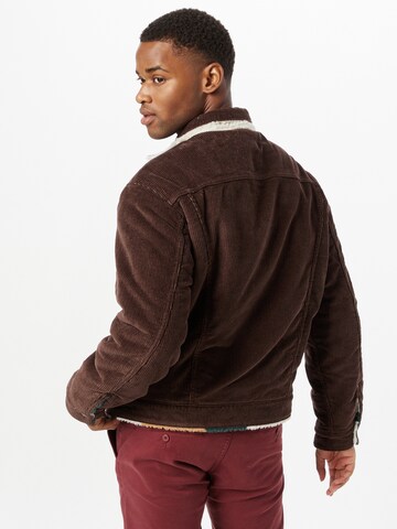 LEVI'S ® Between-Season Jacket 'Levi's® Men's Reversible Vintage Fit Sherpa Trucker Jacket' in Brown