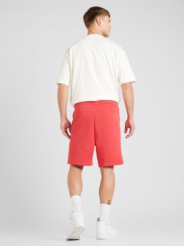 Loosefit Pantalon 'Tech Fleece' Nike Sportswear en rouge