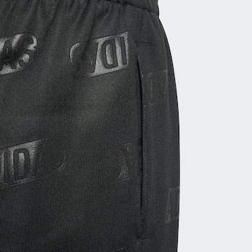 ADIDAS SPORTSWEAR Tapered Workout Pants 'Brand Love Debossed' in Black