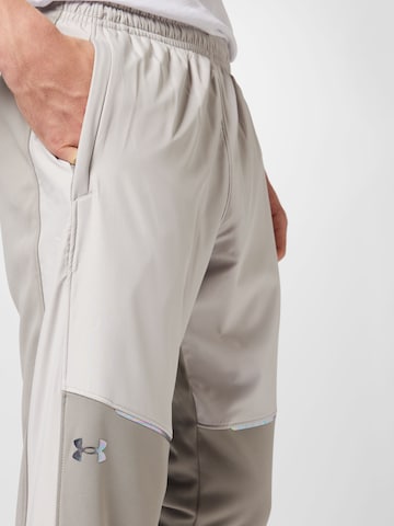 UNDER ARMOURTapered Sportske hlače 'Storm' - bež boja