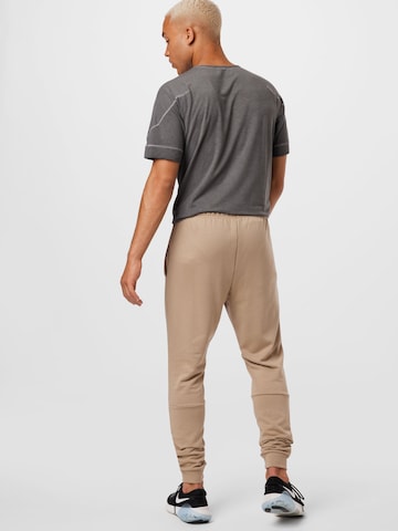NIKE Tapered Sports trousers in Beige