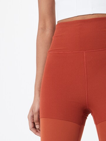 NIKE Skinny Workout Pants in Orange