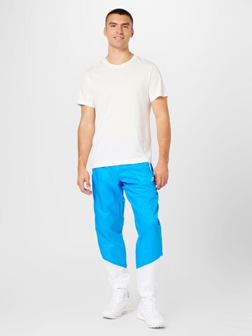 Nike Sportswear Tapered Broek in Blauw