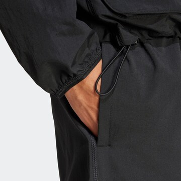 Largi Pantaloni sport 'City Escape' de la ADIDAS SPORTSWEAR pe negru