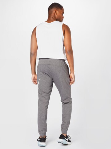 NIKE - Tapered Calças de desporto em cinzento