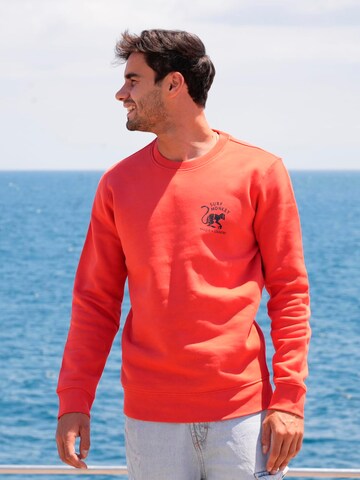Surf Monkey - Sudadera 'Rette das Ozean' en rojo