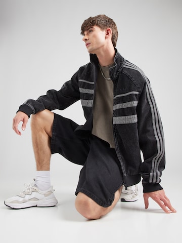 ADIDAS ORIGINALS Преходно яке 'FIRST' в черно